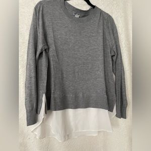 Soft grey sweater with white sheath shirttails.